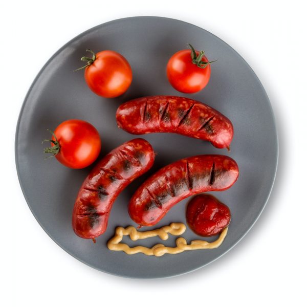 Fried sausages with ketchup on plate